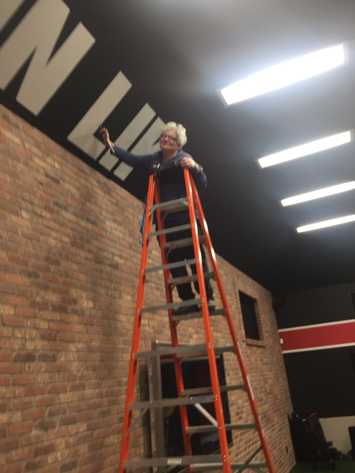Sharon on Ladder at Gym