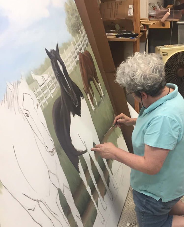 Sharon painting mural with horses