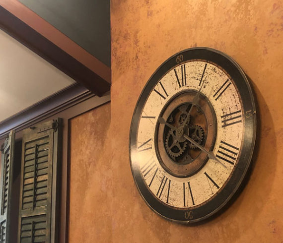 Clock on wall and green cast ceiling