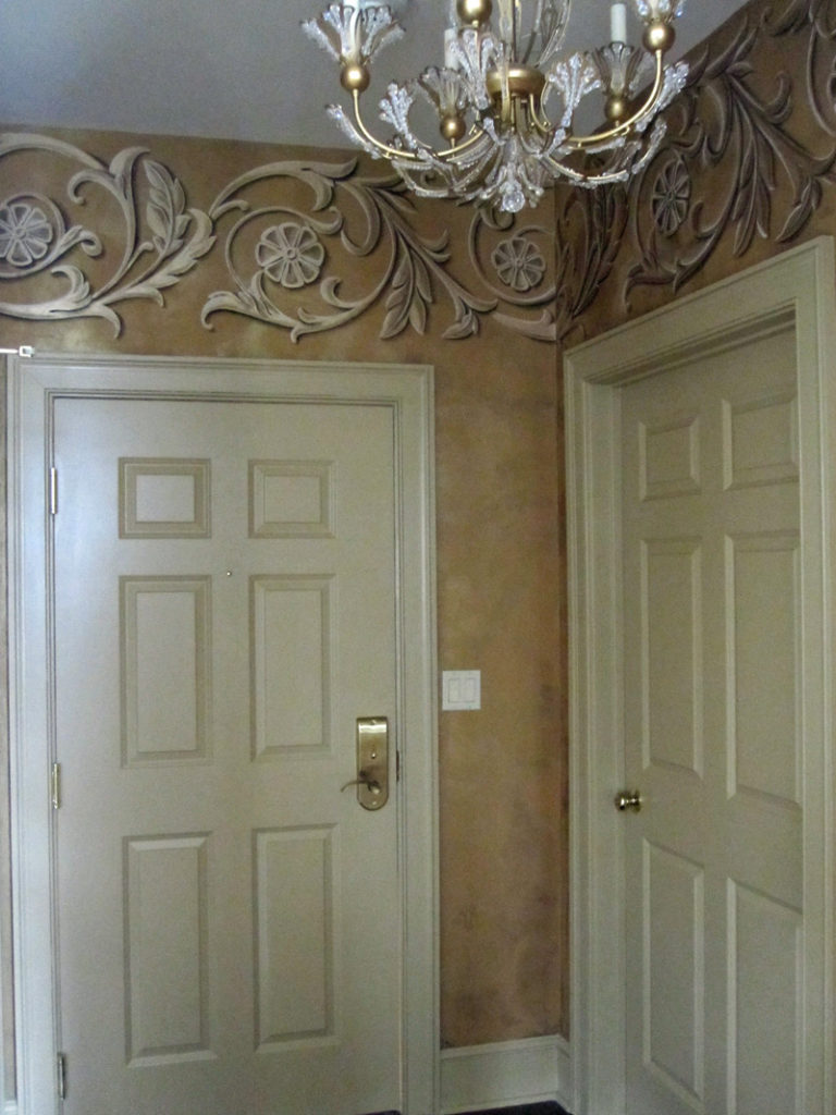 These scrolls were painted in metallic gold with trompe l'oeil shading on walls plastered with LusterStone.