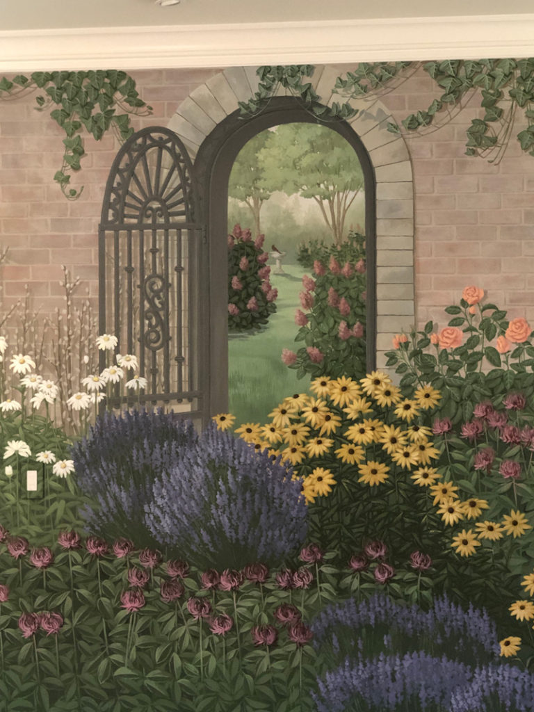 Partial garden shot with door and gate and flowers