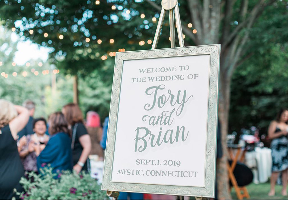 Welcome sign in garden at cocktail hour