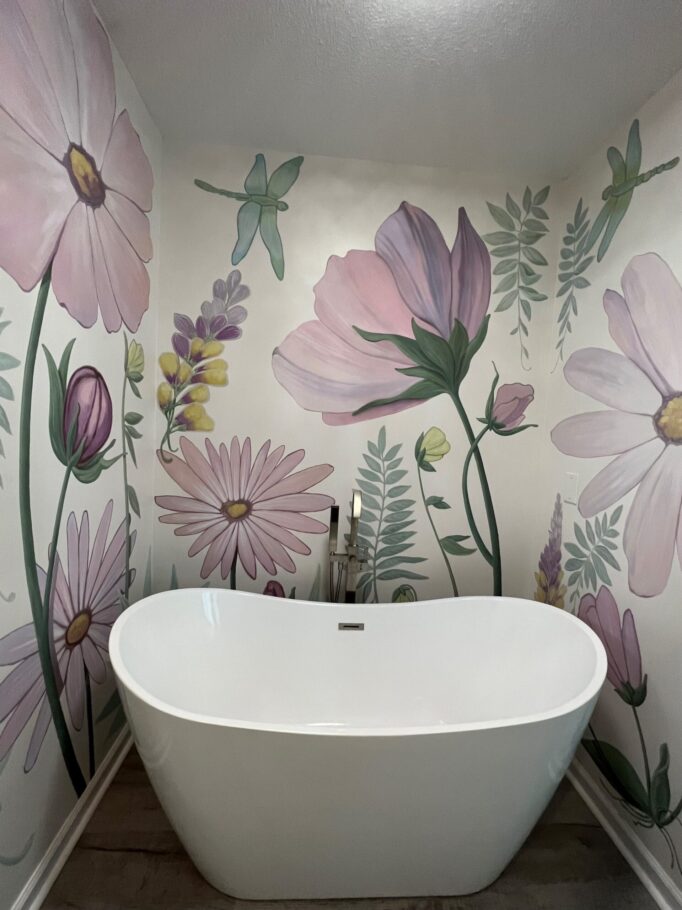 Soaking tub with mural behind it